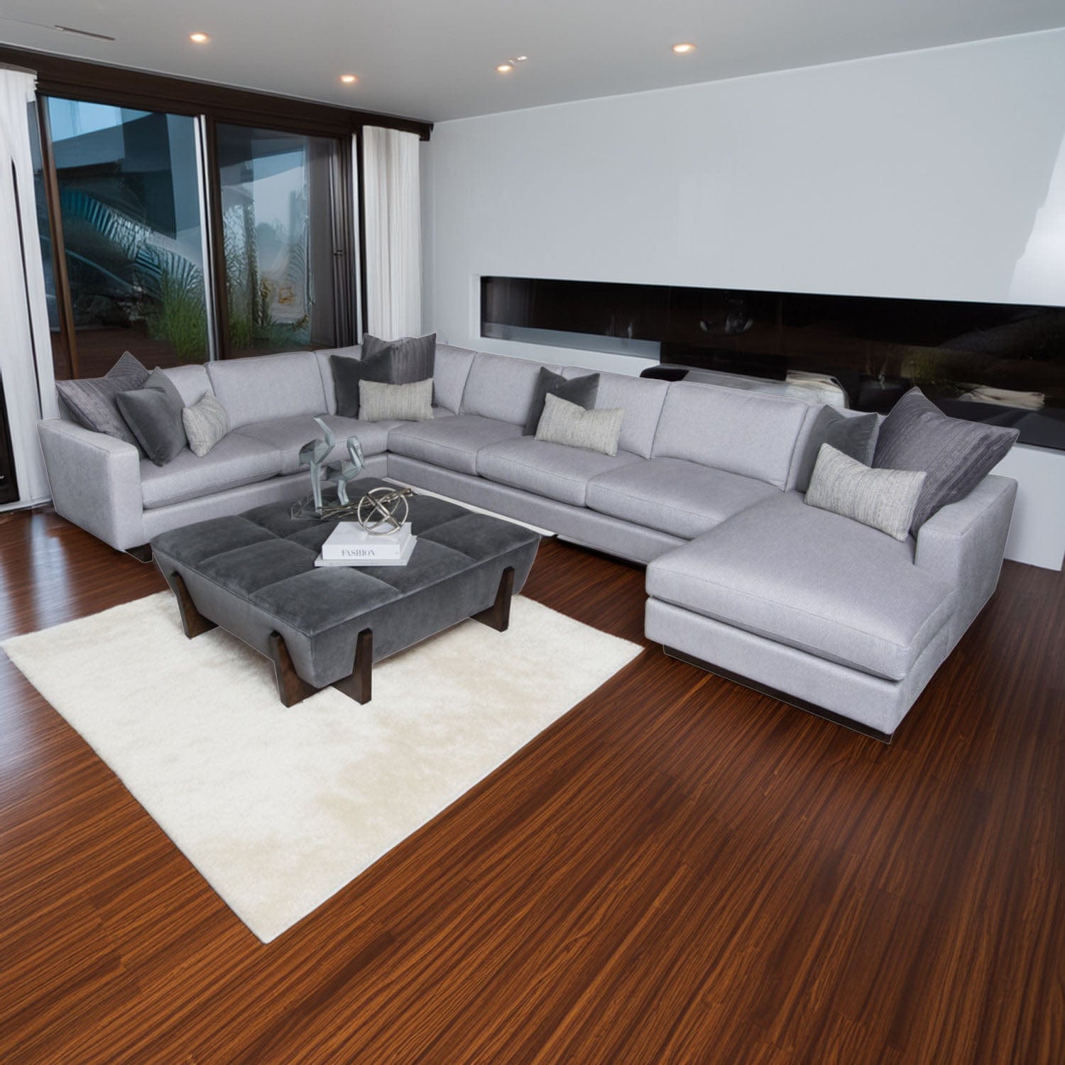 Modern living room with a Leonardo sectional sofa, coffee table, and decorative elements.