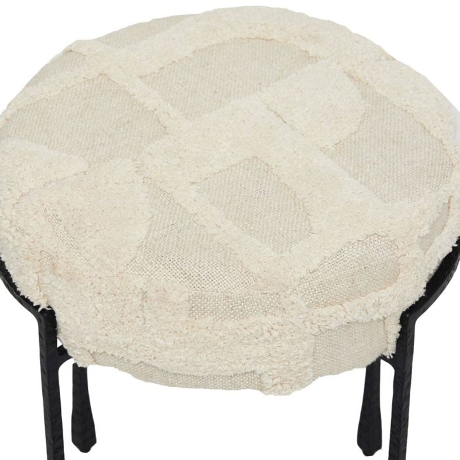 Round ottoman with a textured beige cover on a white background