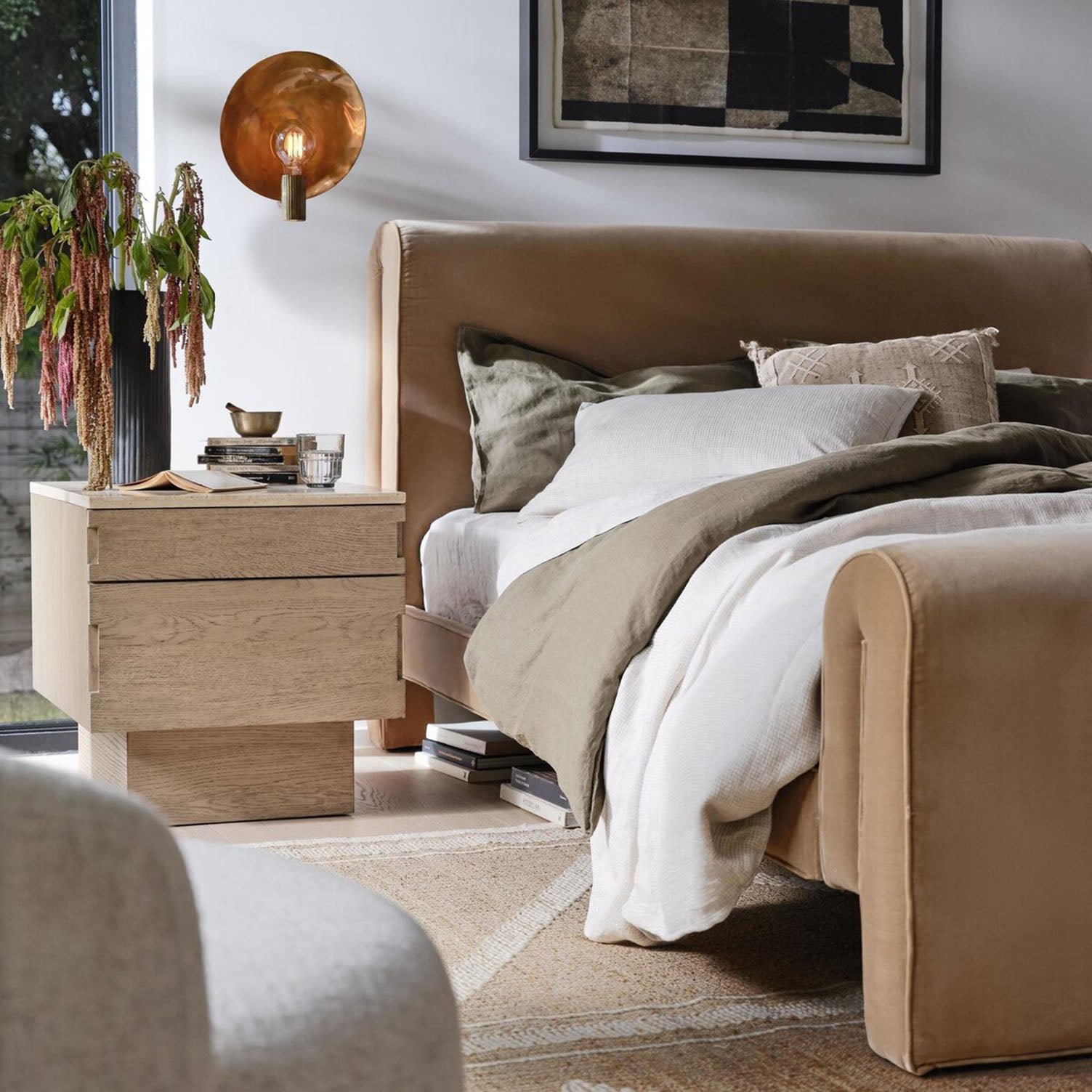 Cozy bedroom with a Four Hands Mitchell Bed in Surrey Camel , nightstand, and decorative elements.