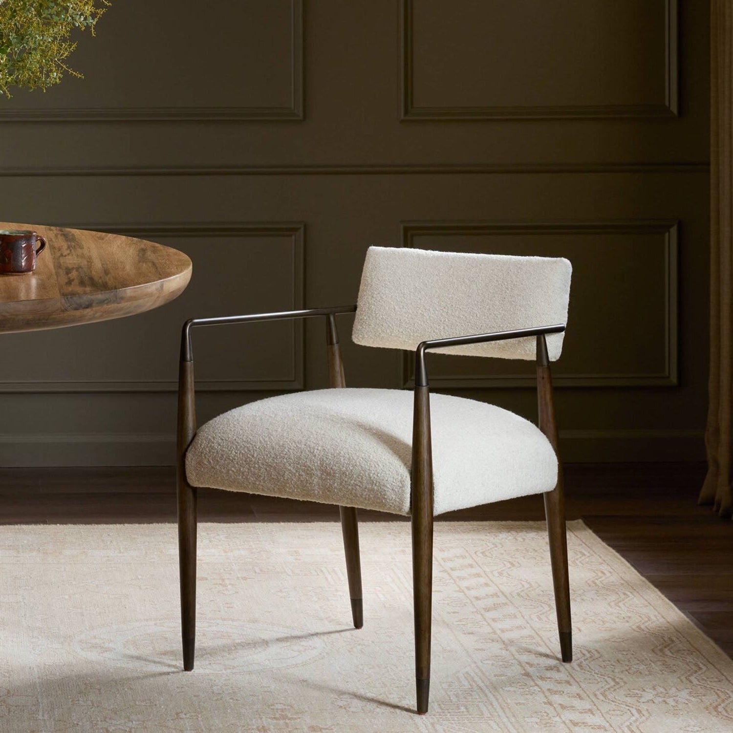 Walden armchair in a room with dark walls and a wooden table.
