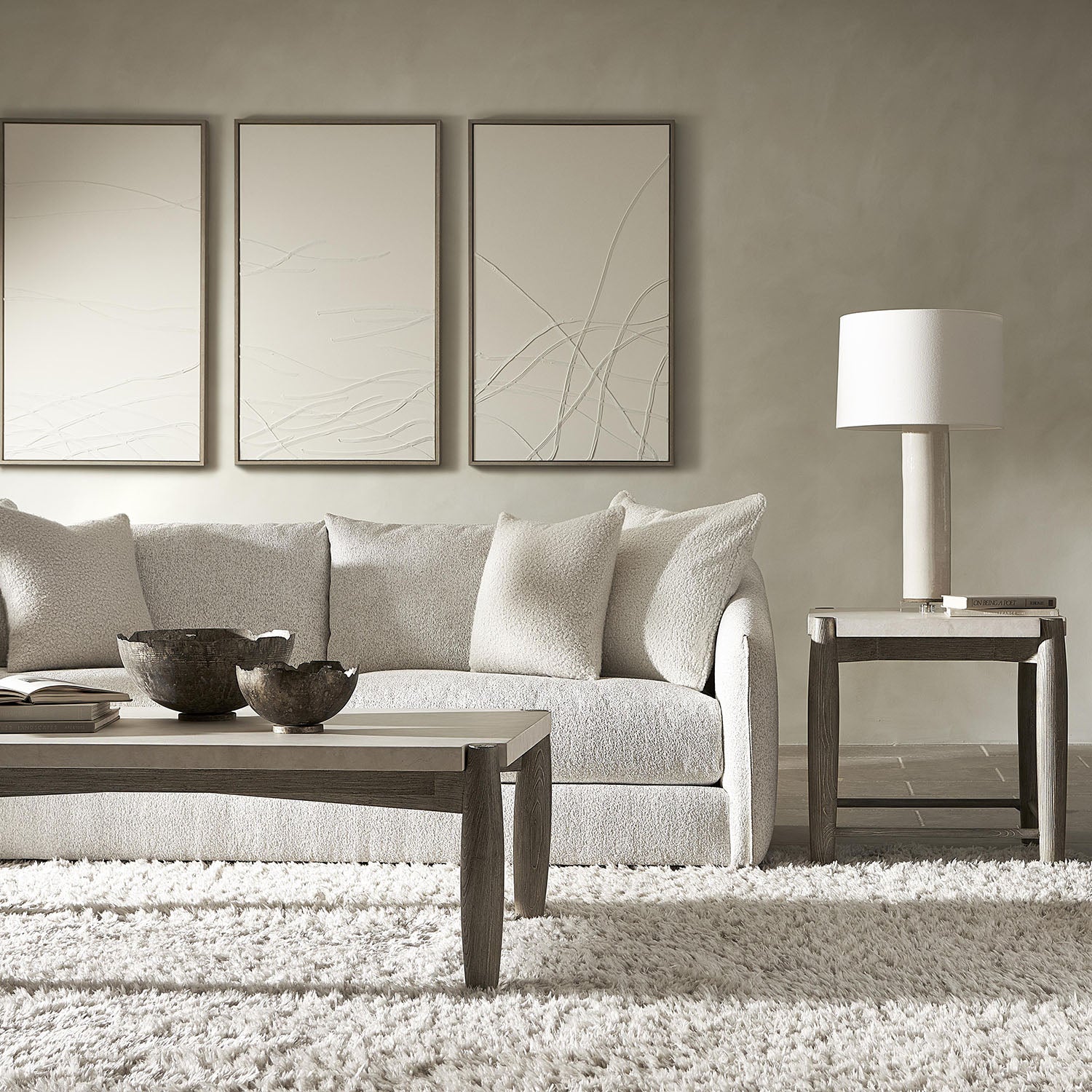 Modern living room with a gray sofa, Bernhardt Ashbrook coffee and end table, and lamp.