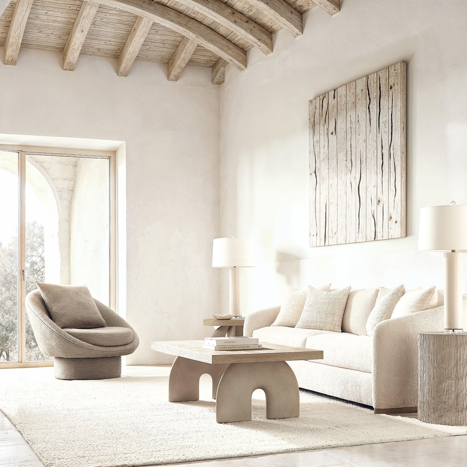 Modern living room with neutral tones, white walls, and wooden ceiling beams.