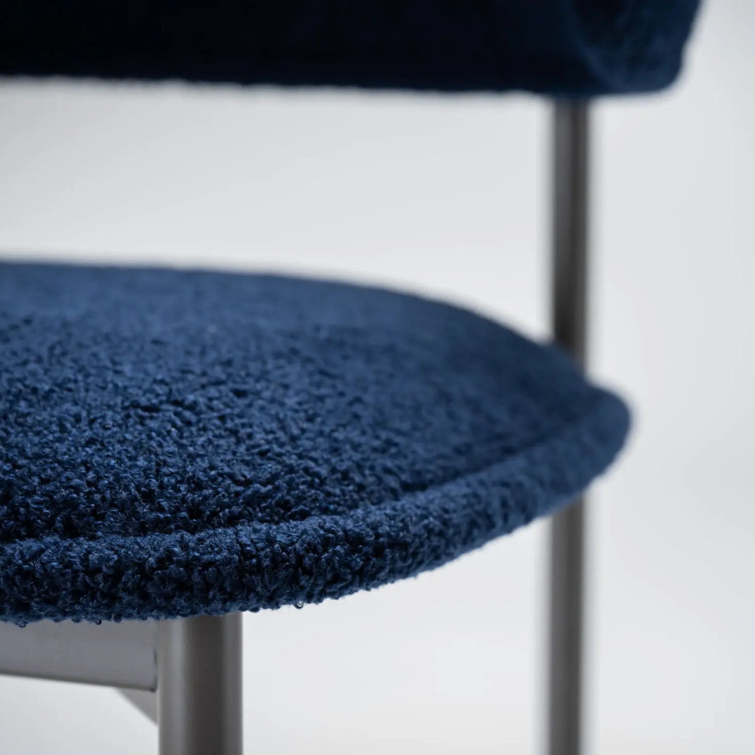 Close-up of a blue textured chair cushion on a white background