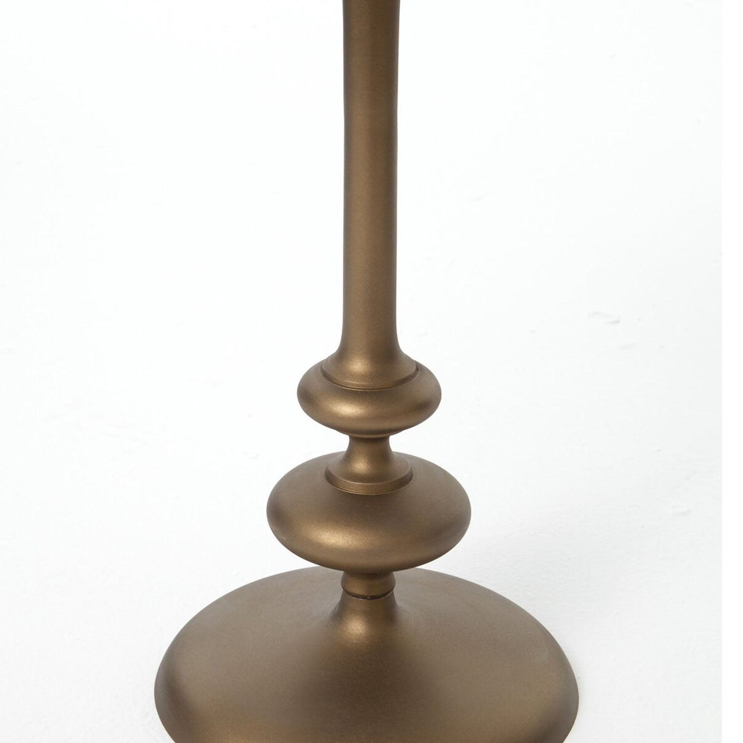 Marlow end table base detail in brass on a white background
