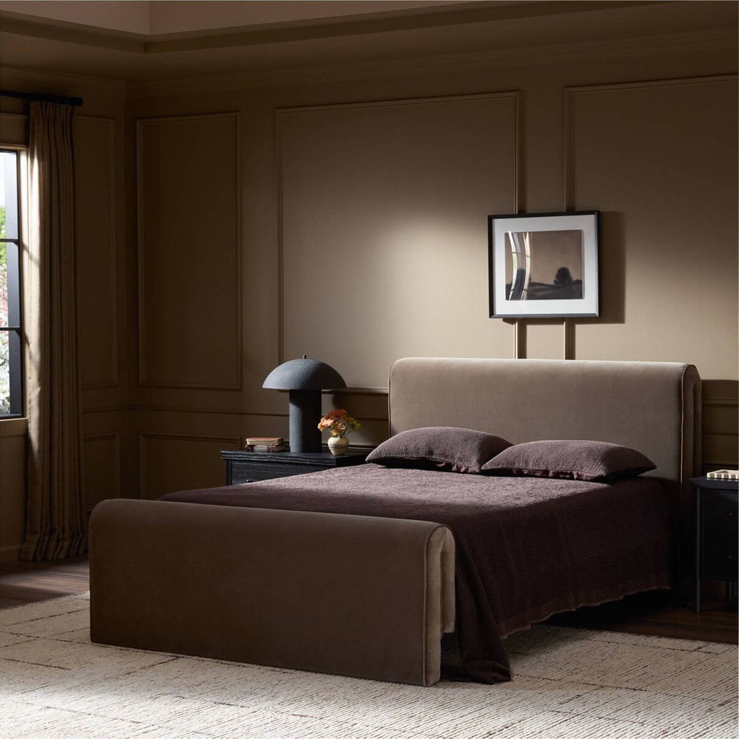 Modern bedroom with a Four Hands Mitchell Bed in Surrey Fossil , lamp, and framed picture on a wall.