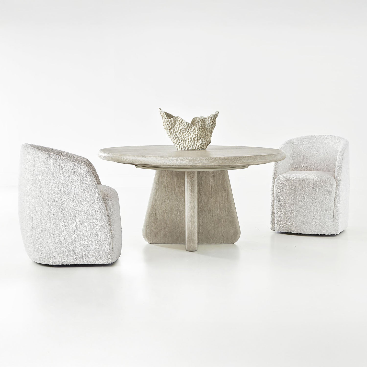 Modern dining set with two Arcadia armchairs and a round table on a white background