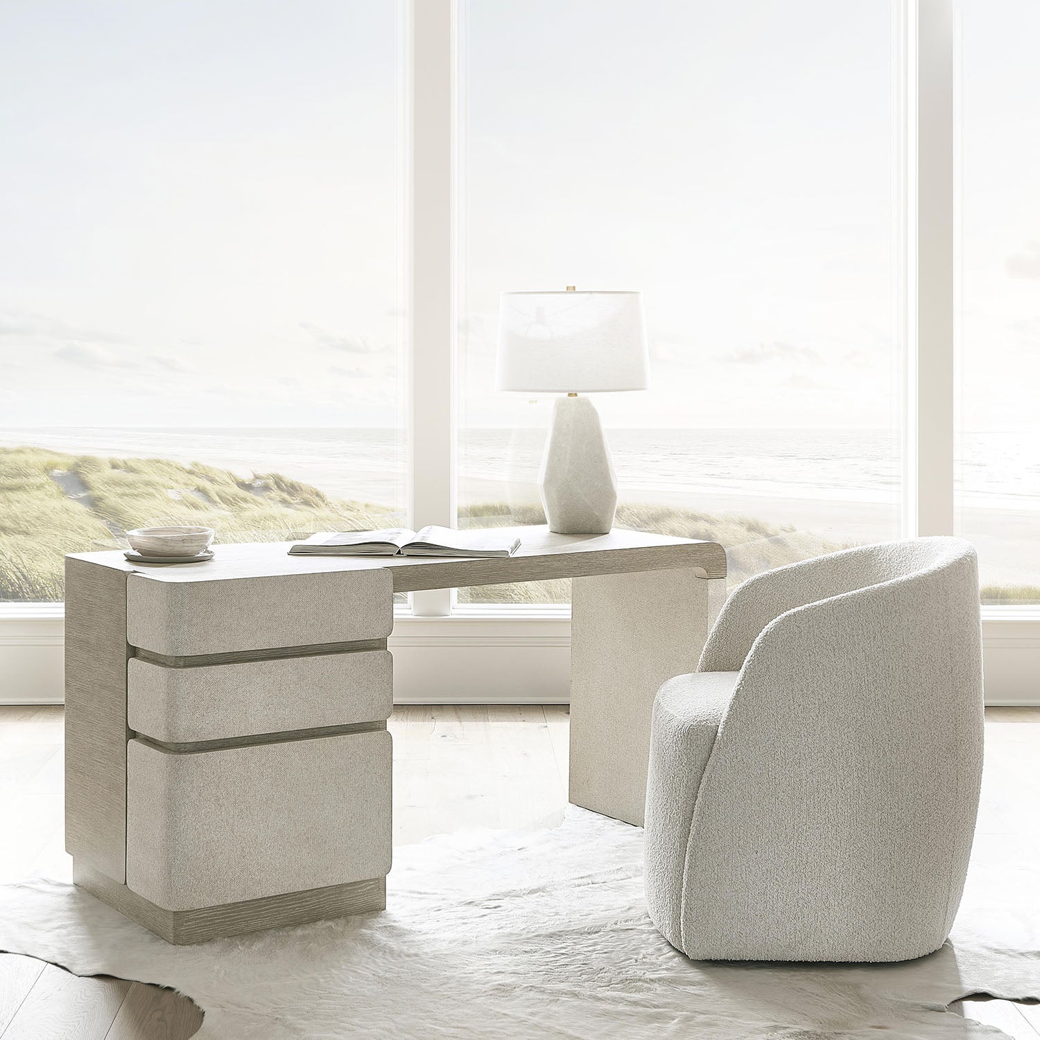 Modern office desk with an Arcadia armchair and lamp in a bright room