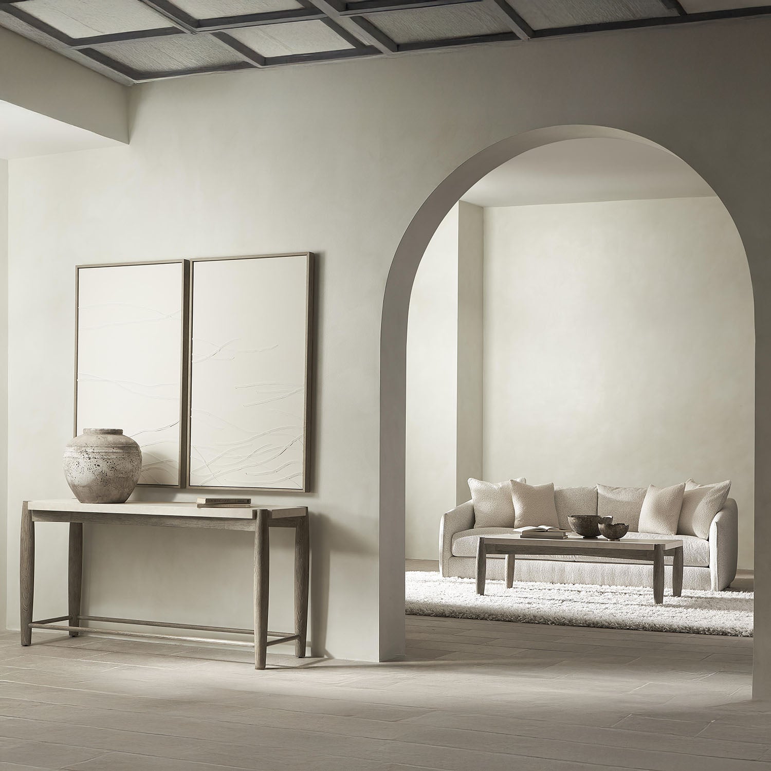 Modern living room with a Bernhardt Ashbrook, coffee table and sofa table with a couch and decorative items.