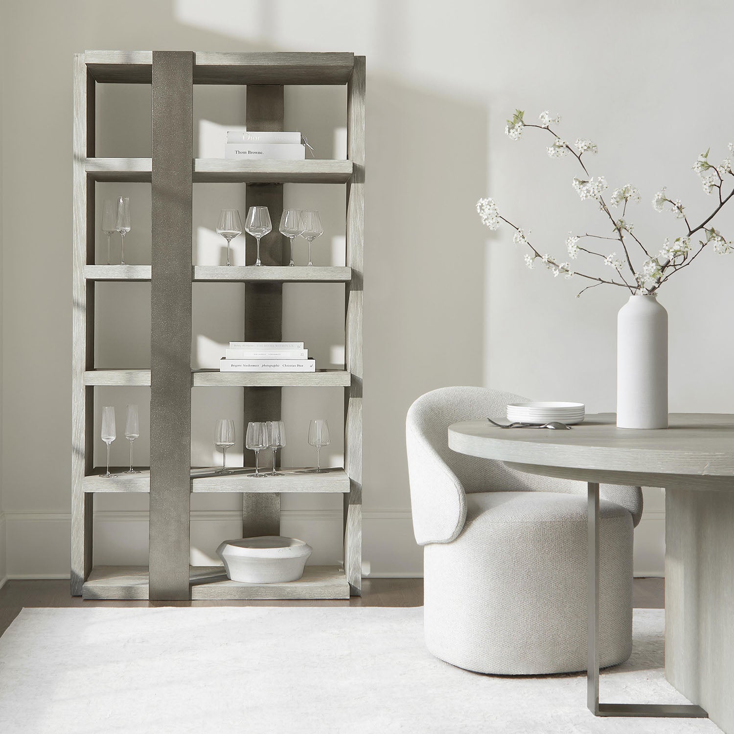 Modern dining room with a bookshelf, round table, and a Tempo chair.