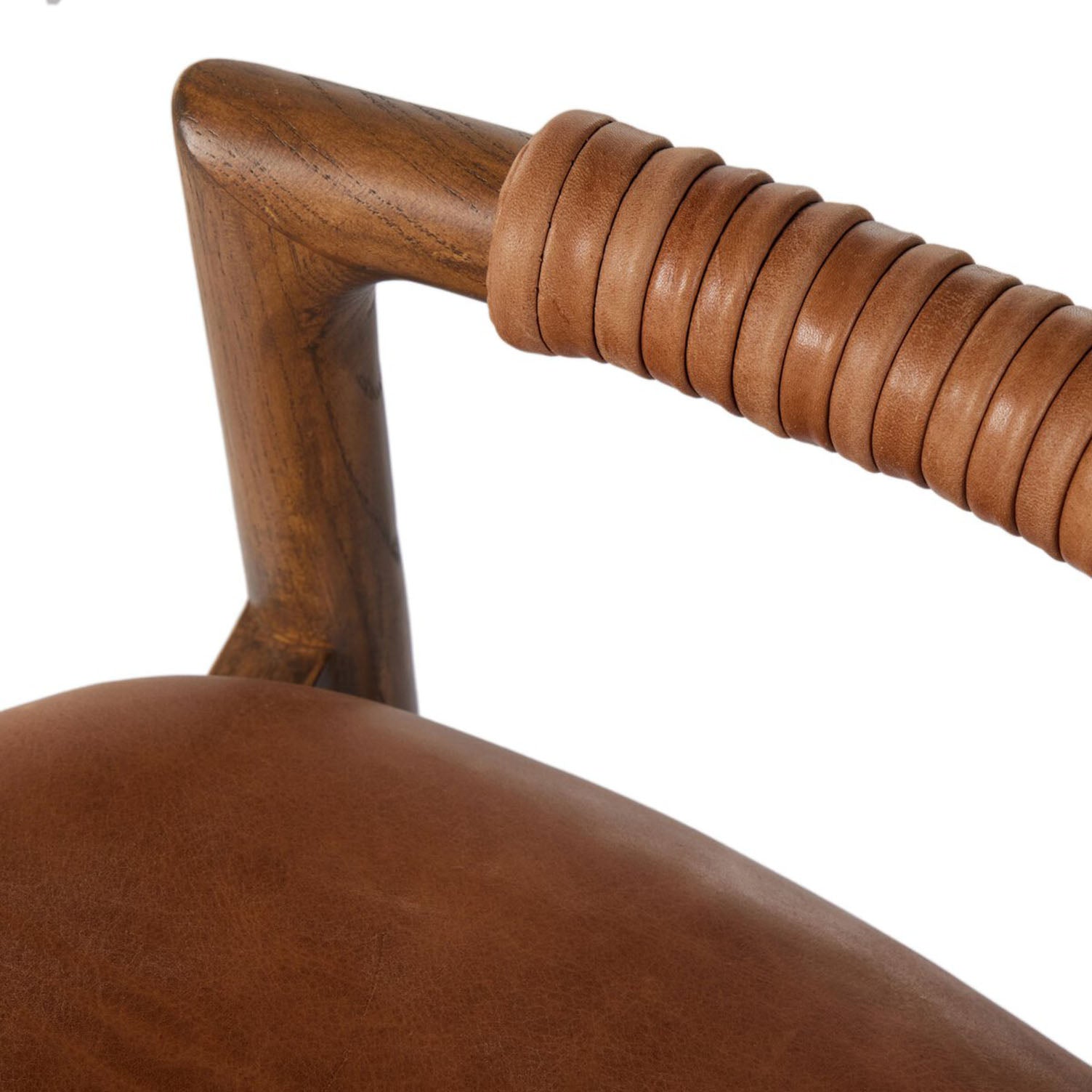 Close-up of a brown leather chair with wooden back rest on a white background