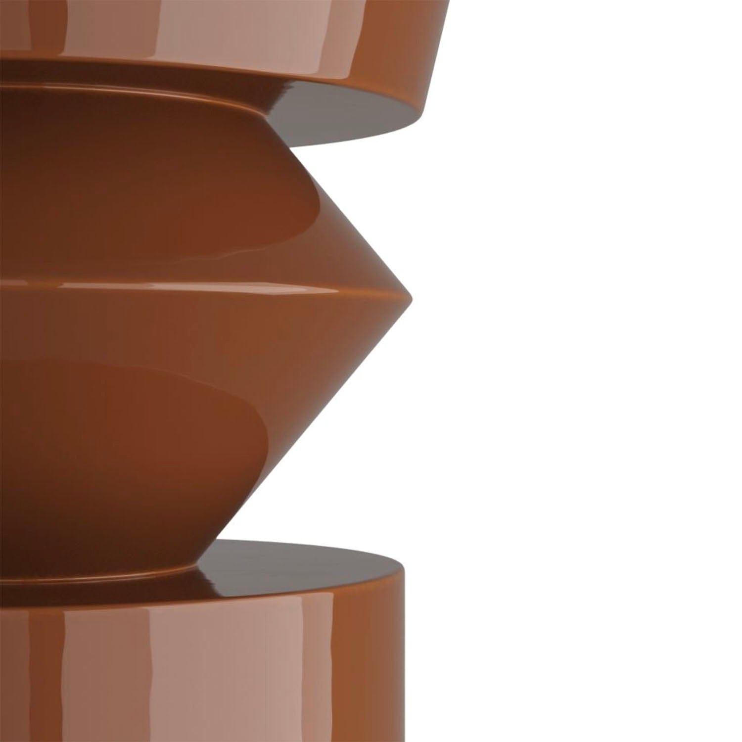 Close-up of a paprika color end table with a white background